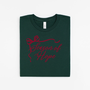 Green t-shirt with red text and bow design on a white background