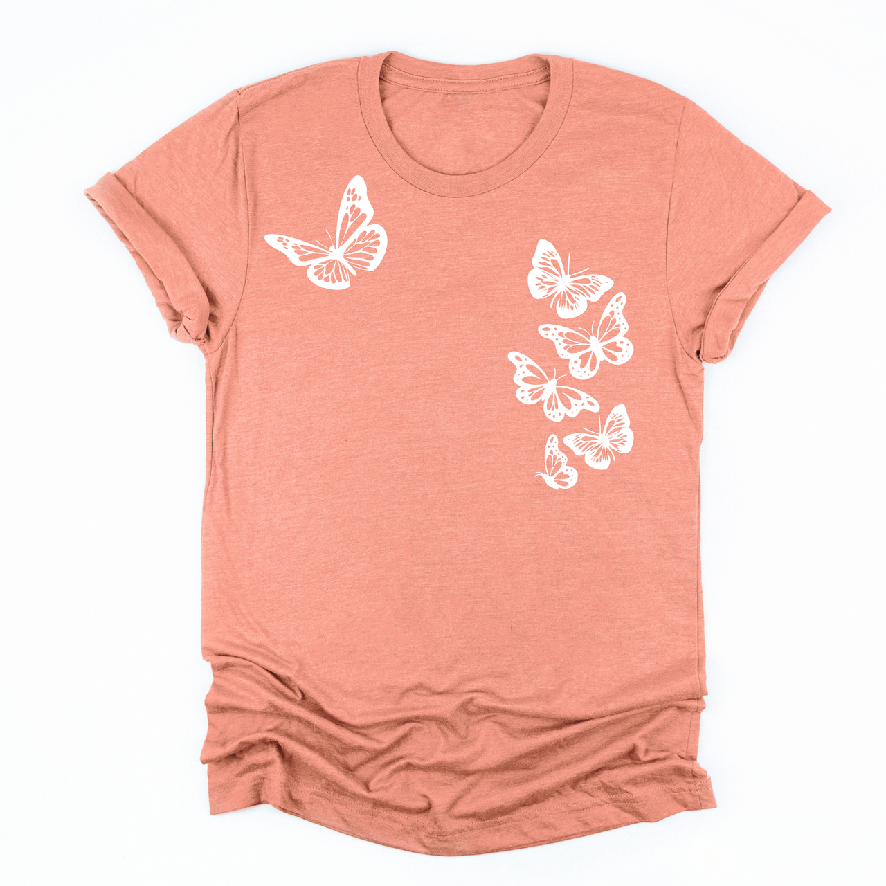 a sunset orange tee with six white butterflies symbolizing the 1 in 6 infertility statistic