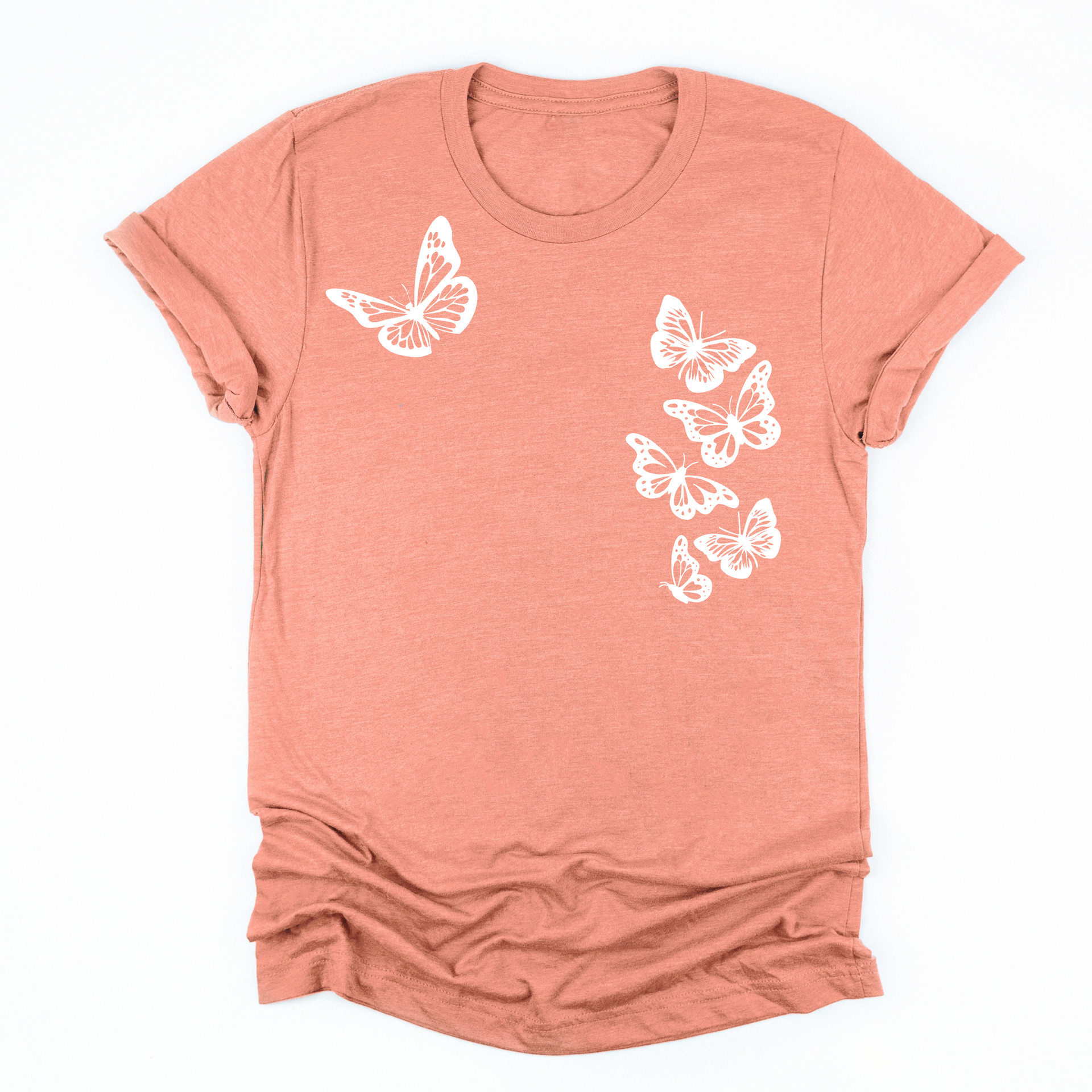 a sunset orange tee with six white butterflies symbolizing the 1 in 6 infertility statistic