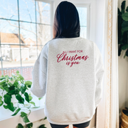 Back Design Alt Text
Woman wearing a heather gray crewneck with infertility-inspired “All I Want for Christmas Is You” message on the back, standing indoors near bright windows.