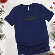 Navy blue t-shirt with Christmas tree design on a white background with holiday decorations.